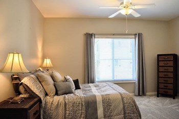 furnished bedroom with ceiling fan